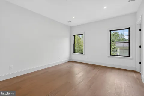 a kitchen with stainless steel appliances granite countertop a kitchen island a table and chairs in it