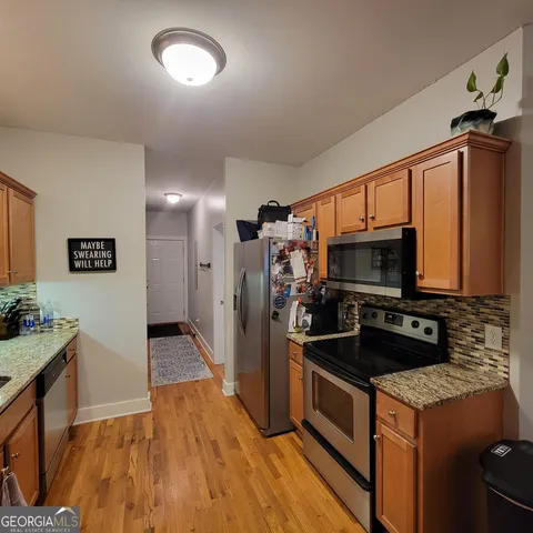 a kitchen with a sink stove and refrigerator