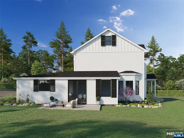 a front view of a house with a garden and trees