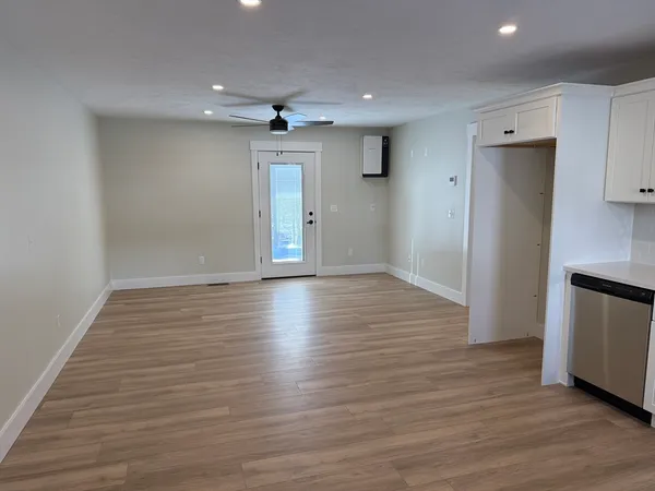 a view of empty room with wooden floor