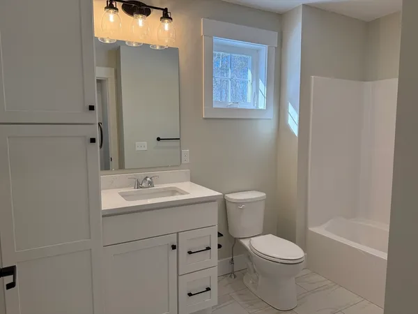 a bathroom with a toilet a sink and a bathtub