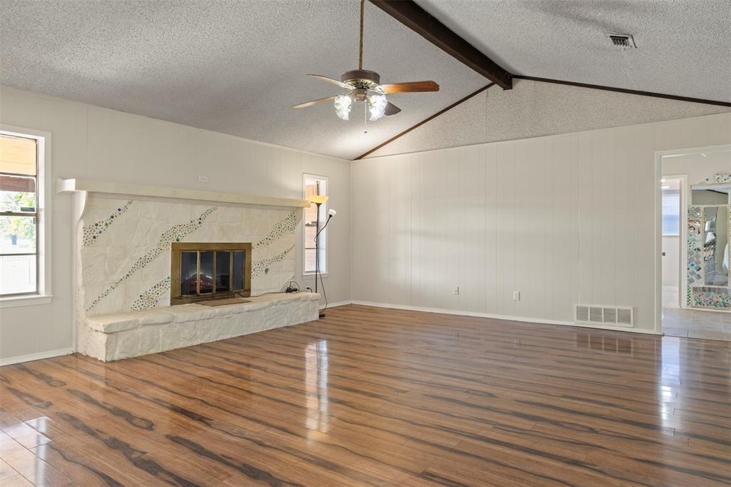 3718 West Rochelle Road Irving, TX 75062 - Photo 11 of 29 a view of an empty room with wooden floor and a fireplace