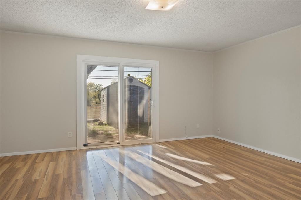 3718 West Rochelle Road Irving, TX 75062 - Photo 16 of 29 a view of empty room with wooden floor and fan