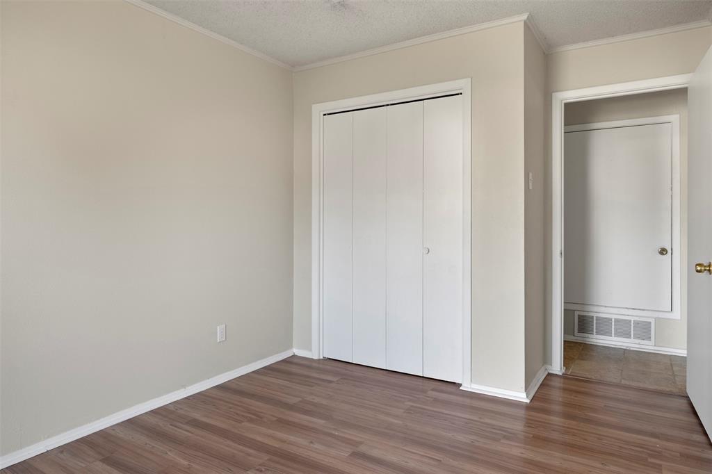 3718 West Rochelle Road Irving, TX 75062 - Photo 20 of 29 a view of an empty room with wooden floor and closet
