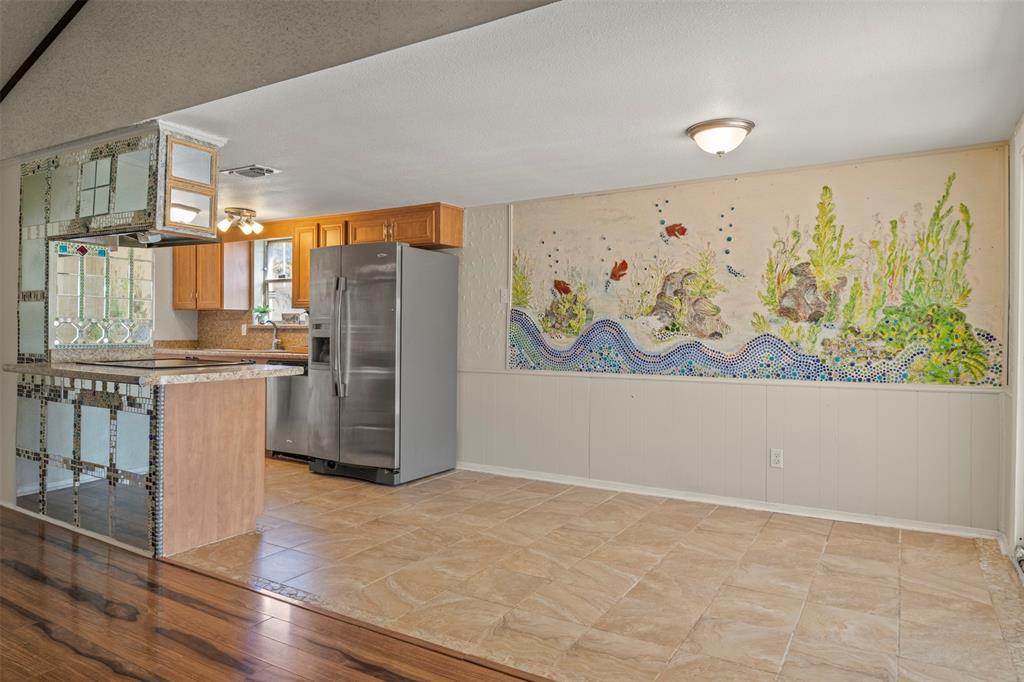3718 West Rochelle Road Irving, TX 75062 - Photo 2 of 29 a kitchen with stainless steel appliances a refrigerator and a stove top oven