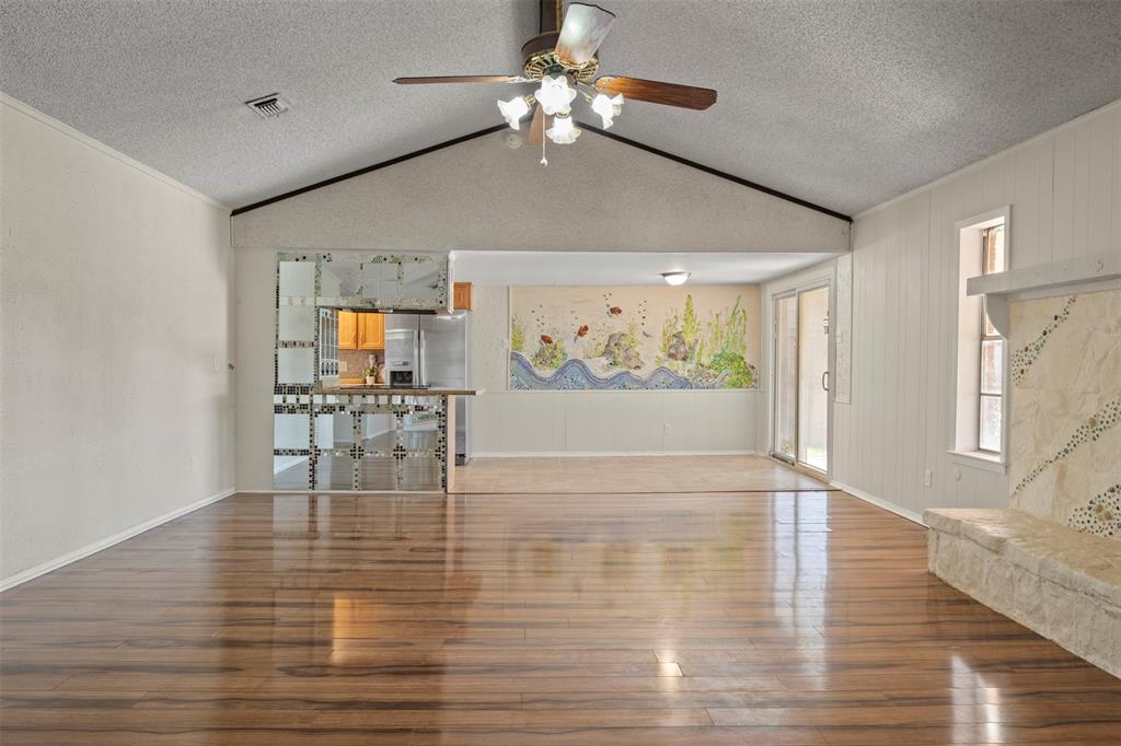 3718 West Rochelle Road Irving, TX 75062 - Photo 3 of 29 a view of dining room with wooden floor and chandelier