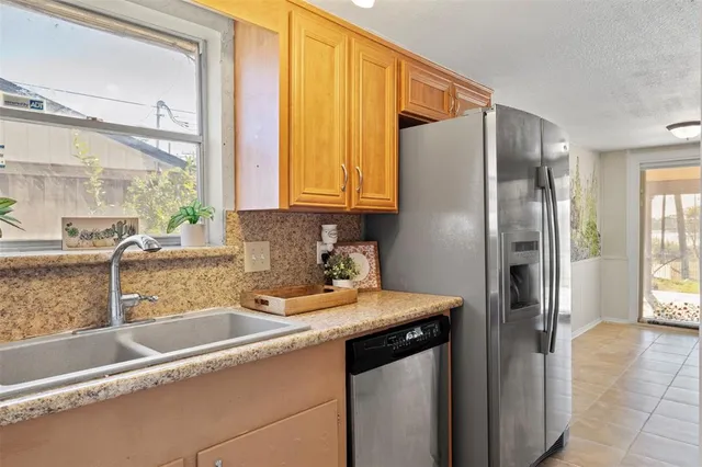 a view of an empty room with wooden floor and a fireplace