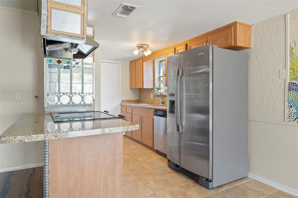 3718 West Rochelle Road Irving, TX 75062 - Photo 9 of 29 a kitchen with stainless steel appliances granite countertop a refrigerator and a stove