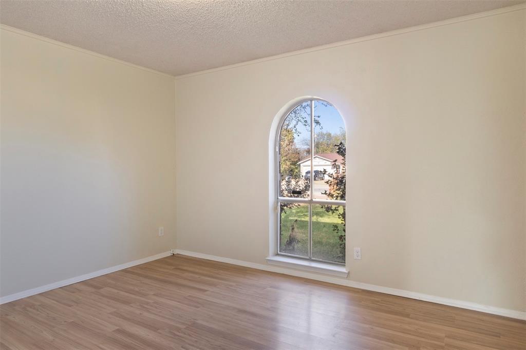 3718 West Rochelle Road Irving, TX 75062 - Photo 10 of 29 an empty room with wooden floor and a window