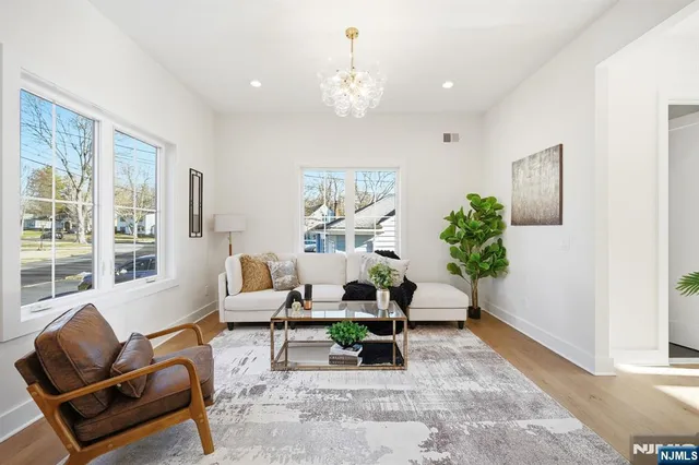 a living room with furniture and a chandelier
