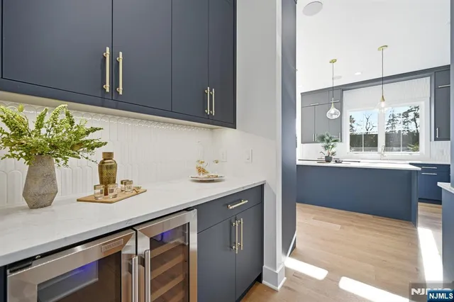 a kitchen with stainless steel appliances granite countertop a sink a stove and cabinets