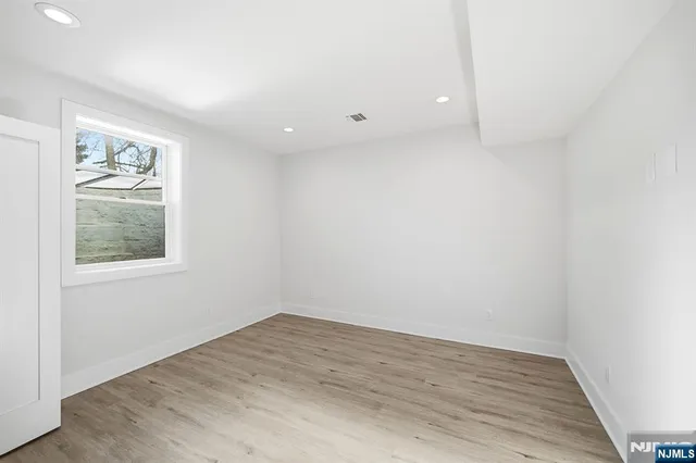an empty room with windows and closet