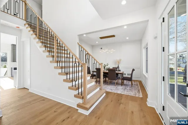 a view of entryway and hall with wooden floor