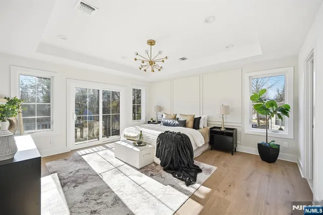 a living room with furniture a chandelier and a rug