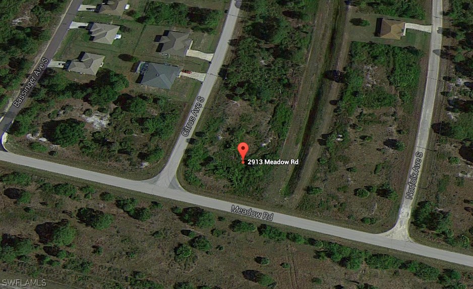 2913 Meadow Road Lehigh Acres, FL 33974 - Photo 6 of 8 an aerial view of a residential houses