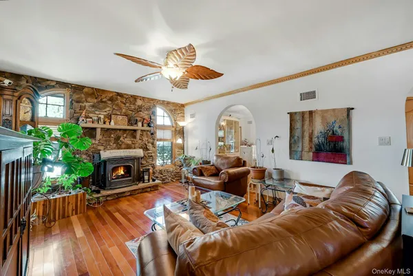 a living room with furniture a chandelier and a flat screen tv