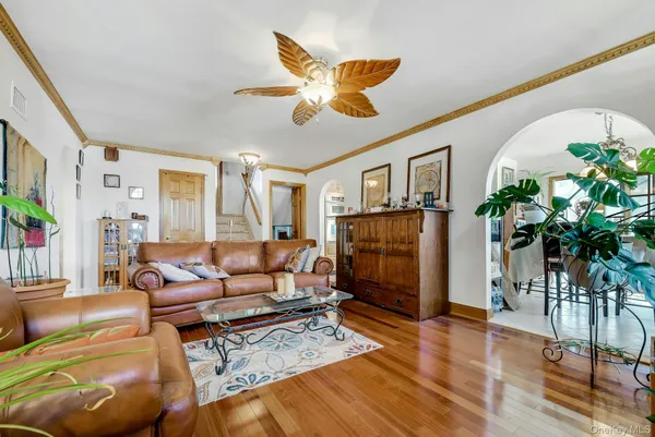 a living room with furniture a chandelier and a flat screen tv