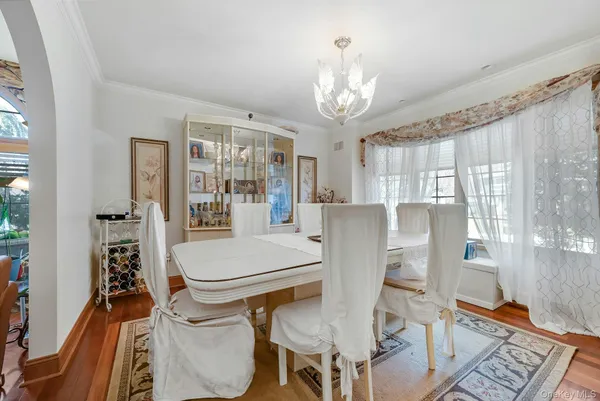 a dining room with furniture and a chandelier