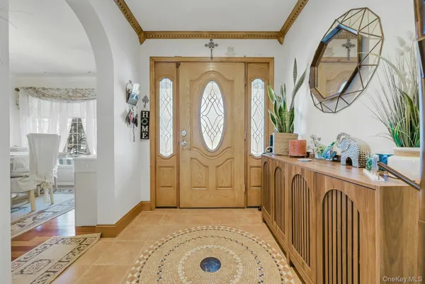 a view of a livingroom with furniture wooden floor mirror and a chandelier