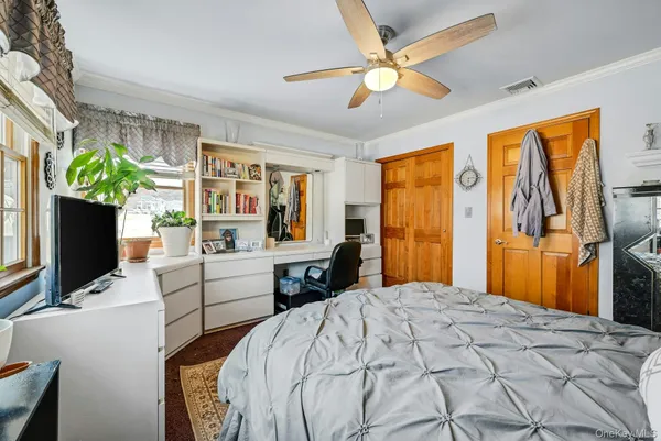 a bedroom with two beds and a chandelier