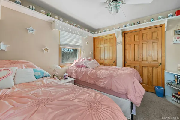 a bedroom with a bed gym equipment and a chandelier