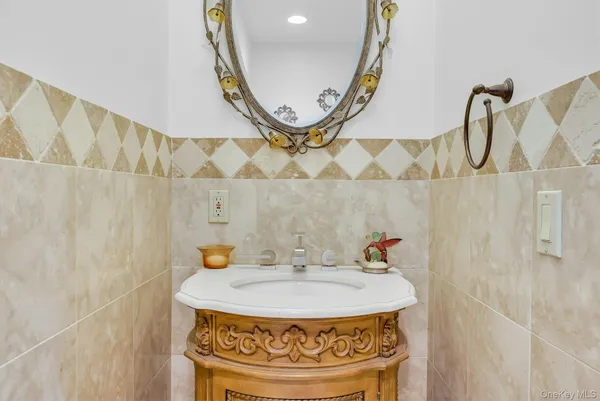 a bathroom with a tub sink and mirror