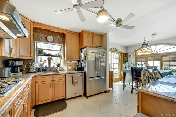 a kitchen with stainless steel appliances granite countertop a refrigerator and a sink