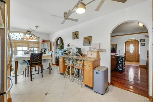 a living room with furniture a dining table and chairs with wooden floor