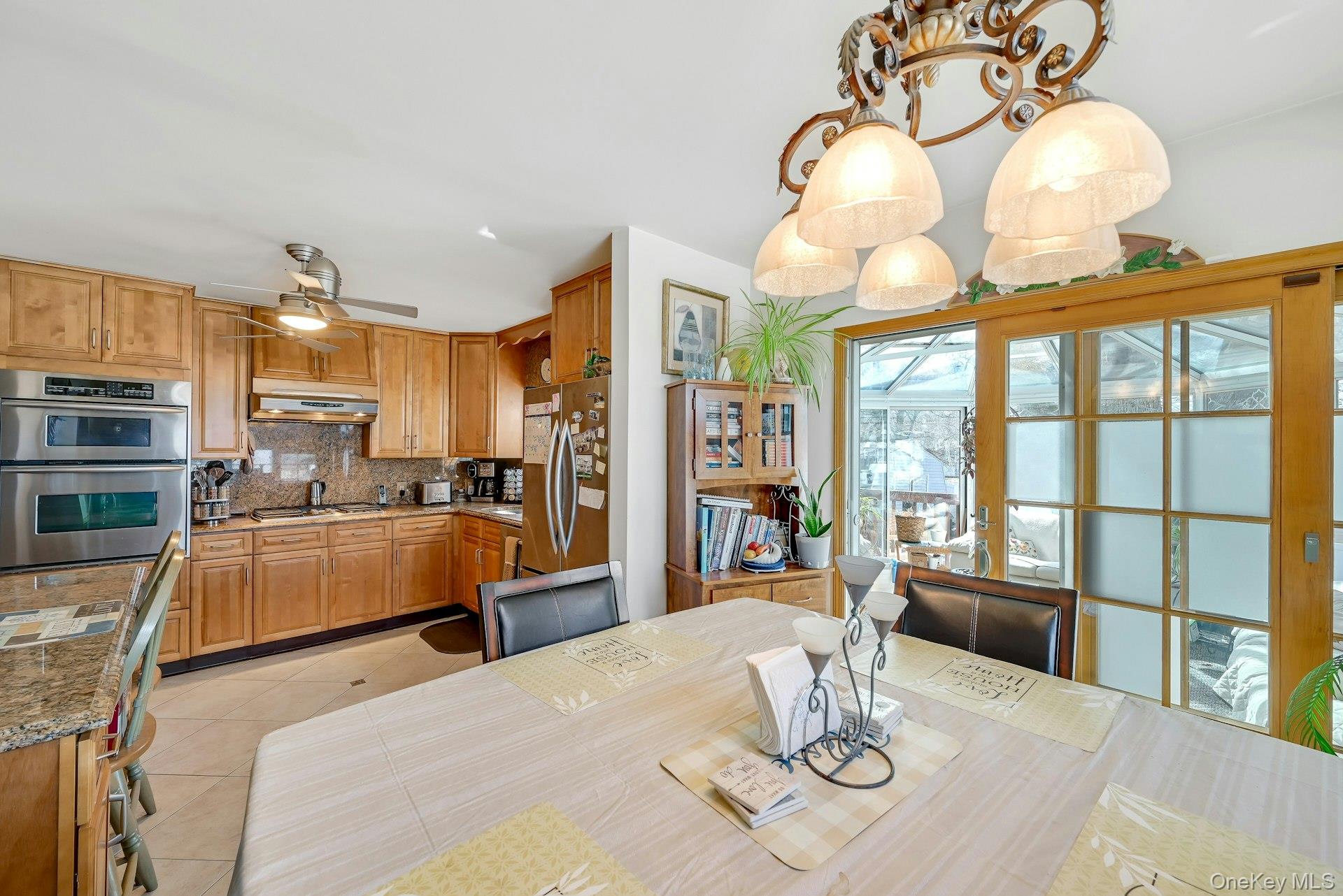 236 Valley Road Valley Cottage, NY 10989 - Photo 7 of 35 a kitchen with stainless steel appliances kitchen island granite countertop a refrigerator a stove and a dining table with wooden floor