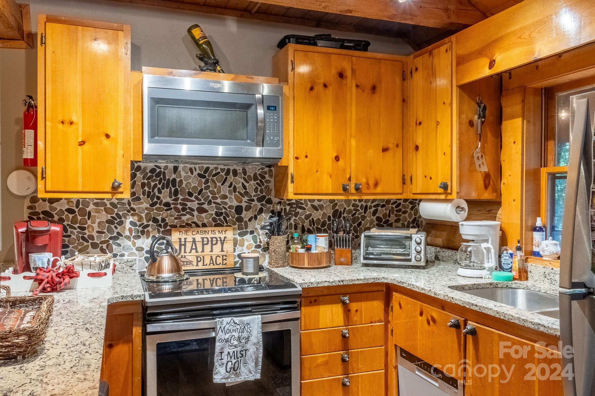 274 Hemlock Road Banner Elk, NC 28604 - Photo 11 of 46 a kitchen with a sink and a stove top oven