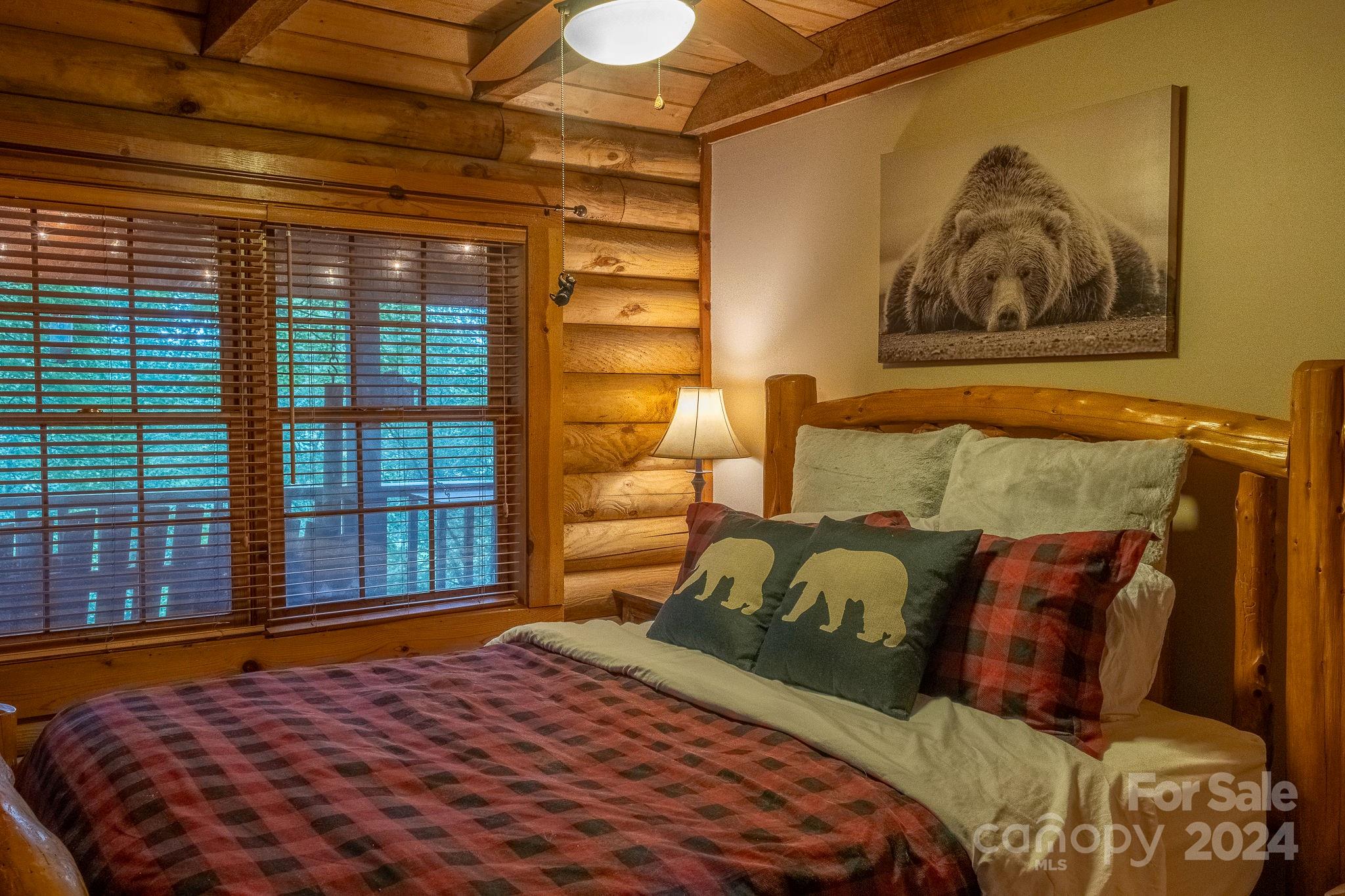 274 Hemlock Road Banner Elk, NC 28604 - Photo 16 of 46 a bed sitting in a bedroom next to a window
