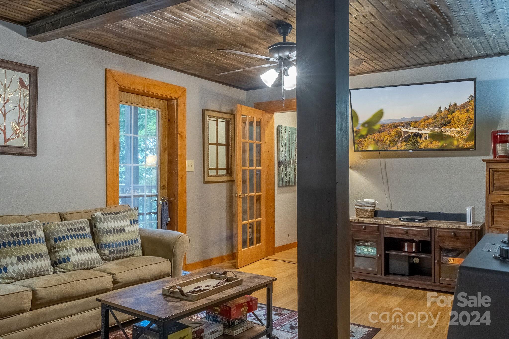 274 Hemlock Road Banner Elk, NC 28604 - Photo 33 of 46 a living room with furniture and a flat screen tv