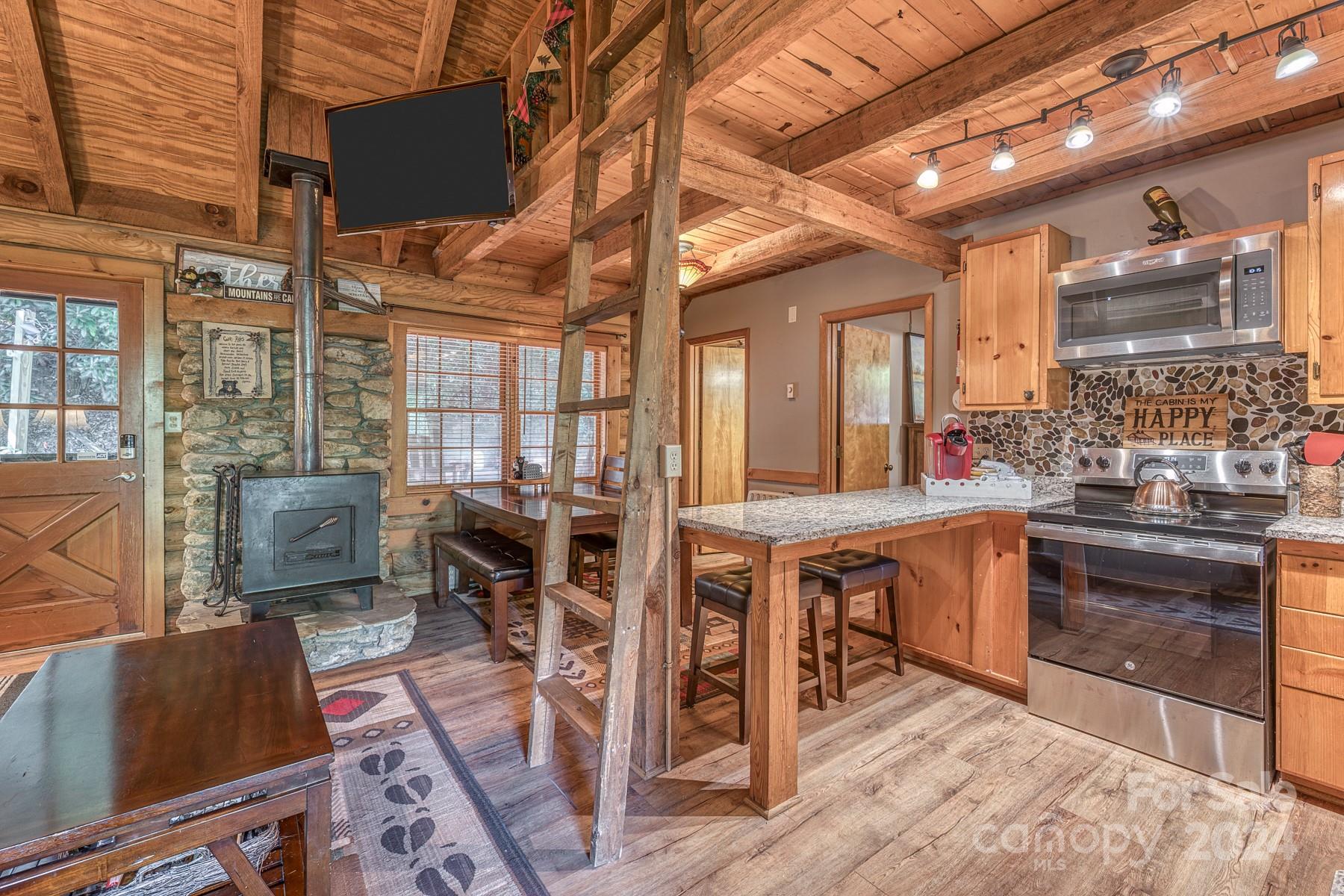 274 Hemlock Road Banner Elk, NC 28604 - Photo 9 of 46 a view of a dining room with furniture window and wooden floor