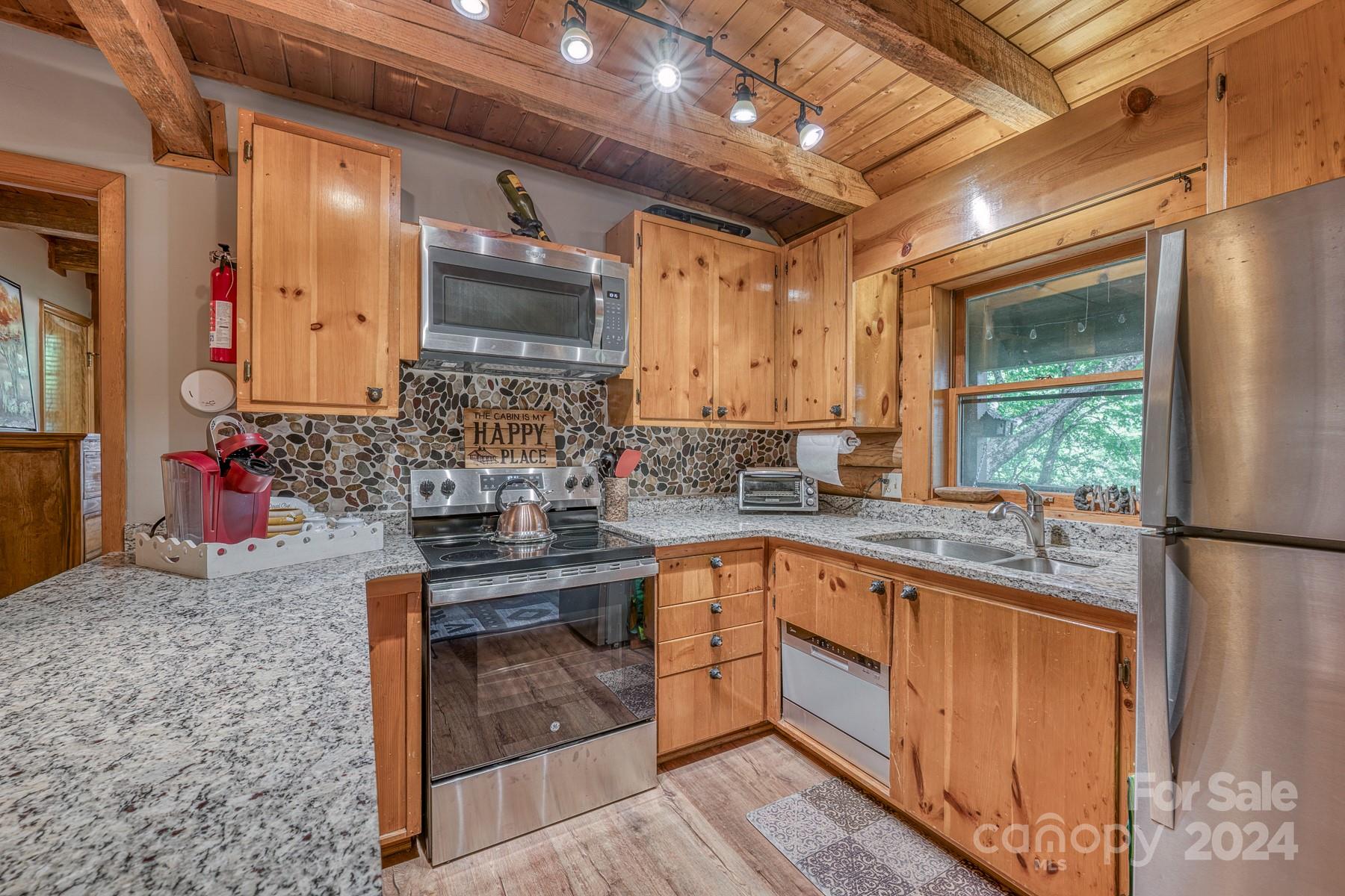274 Hemlock Road Banner Elk, NC 28604 - Photo 10 of 46 a kitchen with stainless steel appliances granite countertop a sink stove and refrigerator
