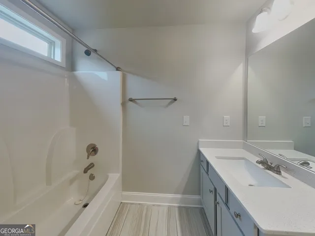 a bathroom with a sink a mirror and a bathtub