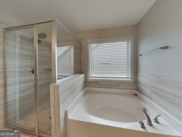 a bathroom with a bathtub and shower