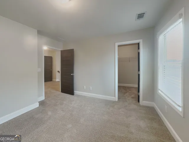 a view of an empty room and closet area