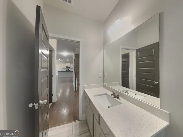 a bathroom with a sink tub and shower