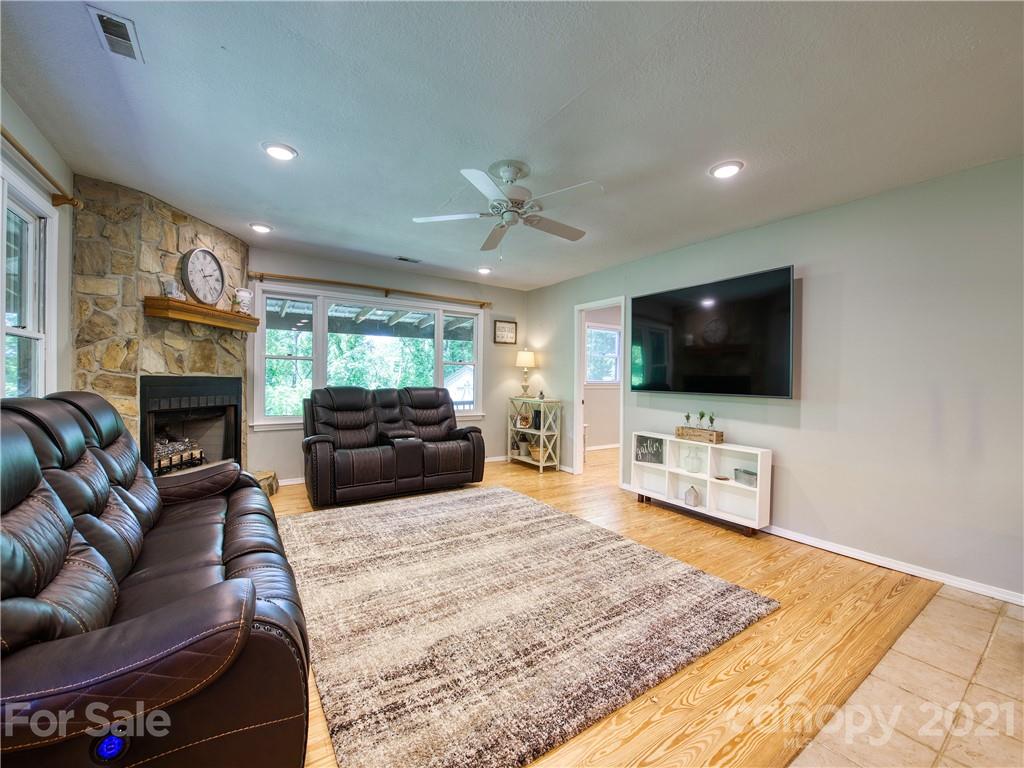 685 Osborne Road Clyde, NC 28721 - Photo 11 of 30 a living room with furniture and a flat screen tv