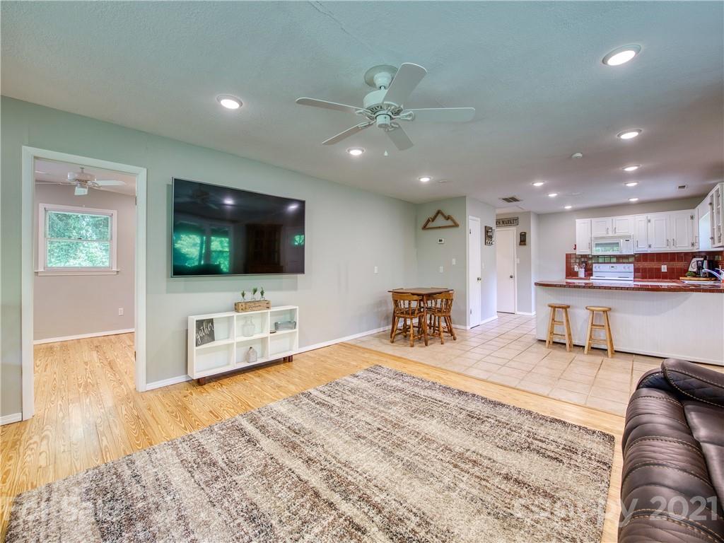 685 Osborne Road Clyde, NC 28721 - Photo 13 of 30 a living room with furniture and a flat screen tv