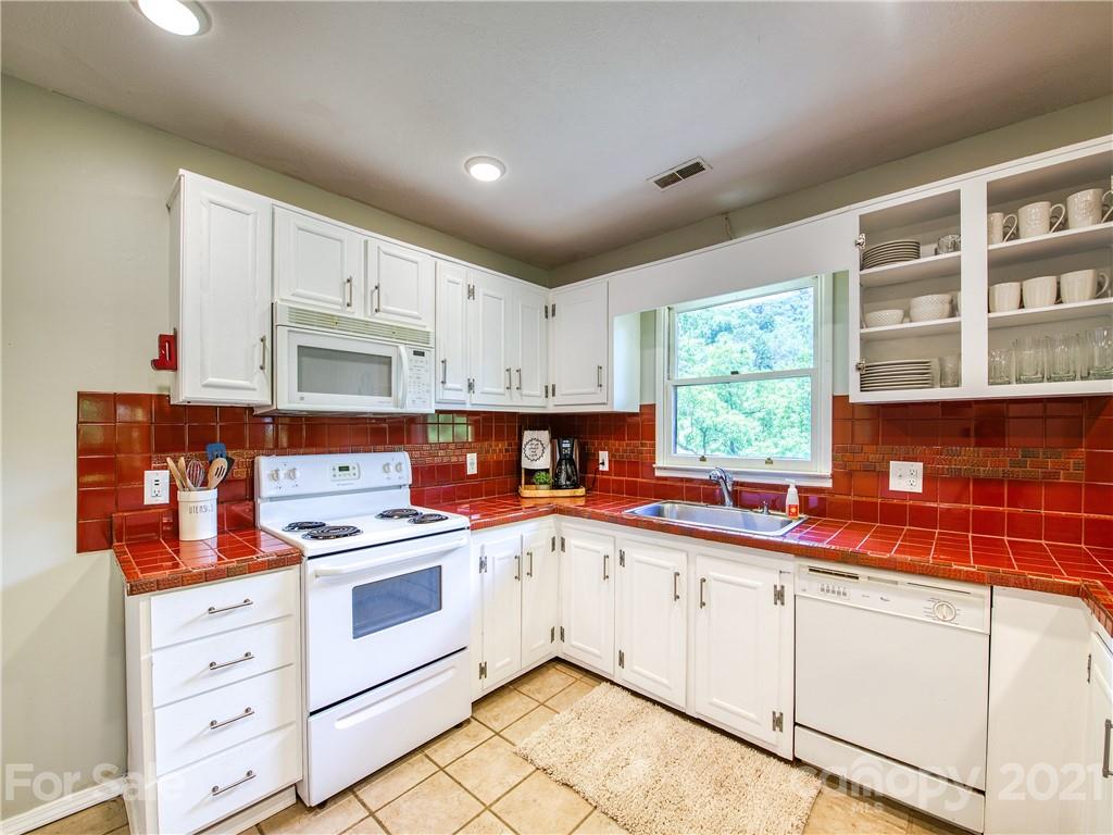 685 Osborne Road Clyde, NC 28721 - Photo 17 of 30 a kitchen with stainless steel appliances granite countertop a sink and cabinets