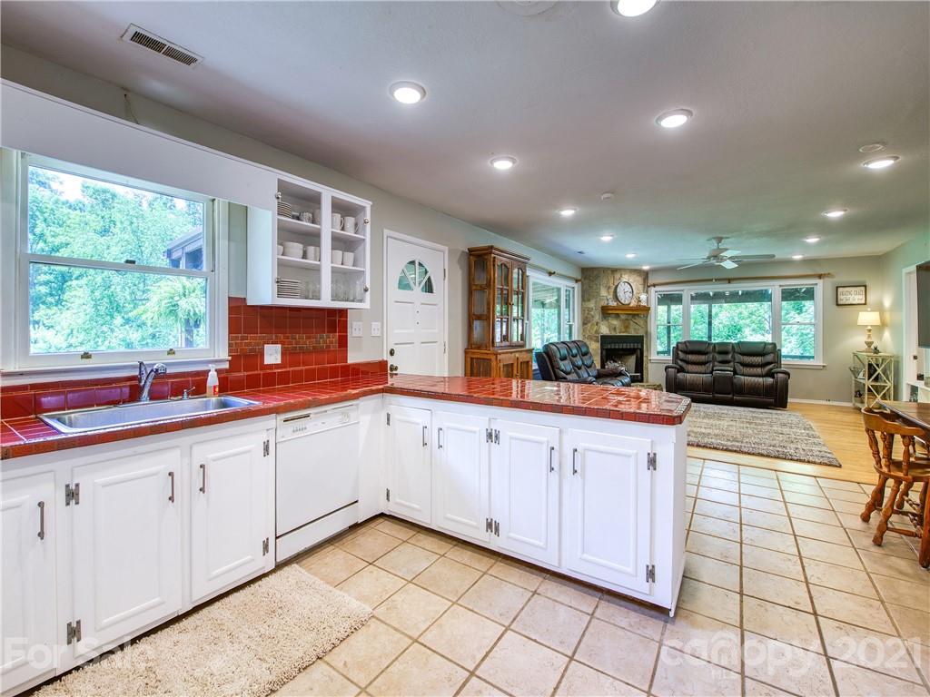 685 Osborne Road Clyde, NC 28721 - Photo 18 of 30 a large white kitchen with a large window and stainless steel appliances