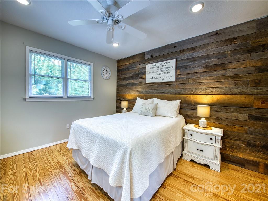 685 Osborne Road Clyde, NC 28721 - Photo 20 of 30 a bedroom with a bed and a night stand