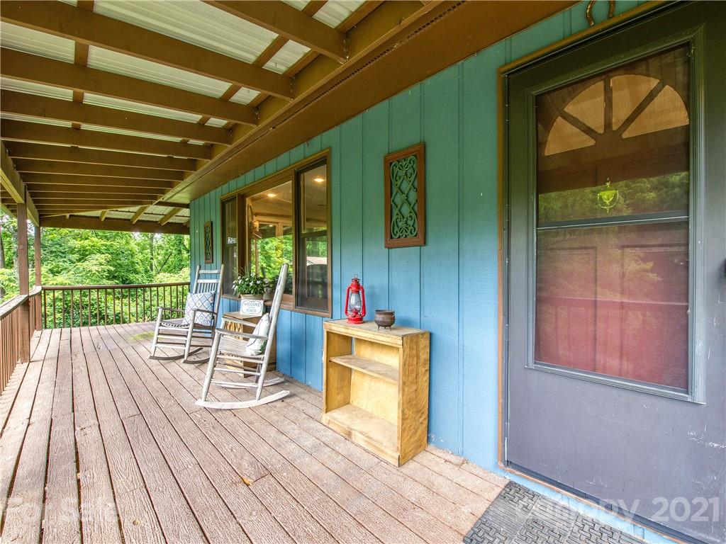 685 Osborne Road Clyde, NC 28721 - Photo 3 of 30 a view of a deck with wooden floor and furniture