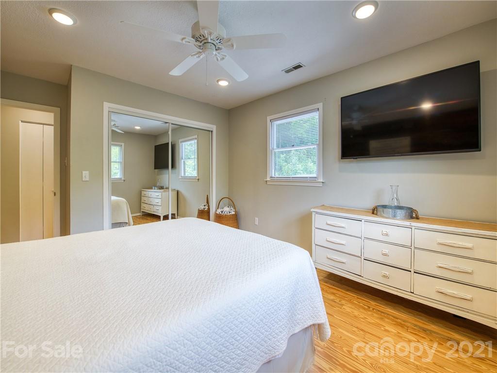 685 Osborne Road Clyde, NC 28721 - Photo 22 of 30 a bedroom with a bed and a flat screen tv