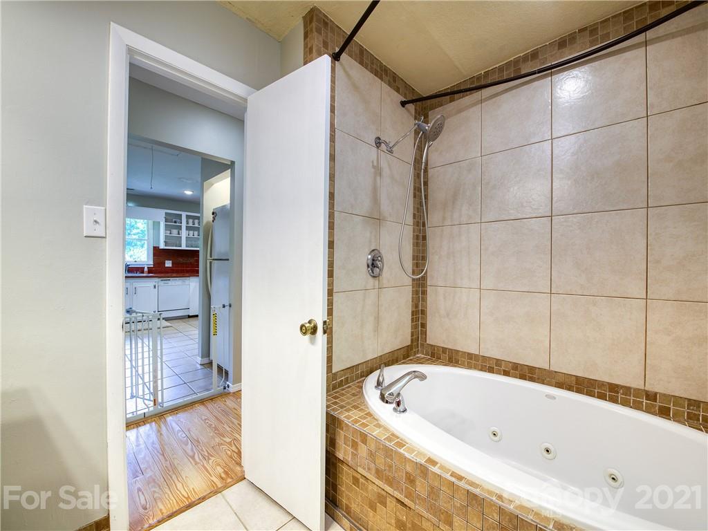 685 Osborne Road Clyde, NC 28721 - Photo 24 of 30 a bathroom with a bathtub and a shower