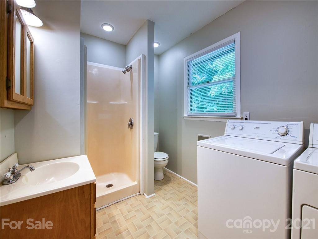 685 Osborne Road Clyde, NC 28721 - Photo 27 of 30 a bathroom with a granite countertop sink toilet and shower