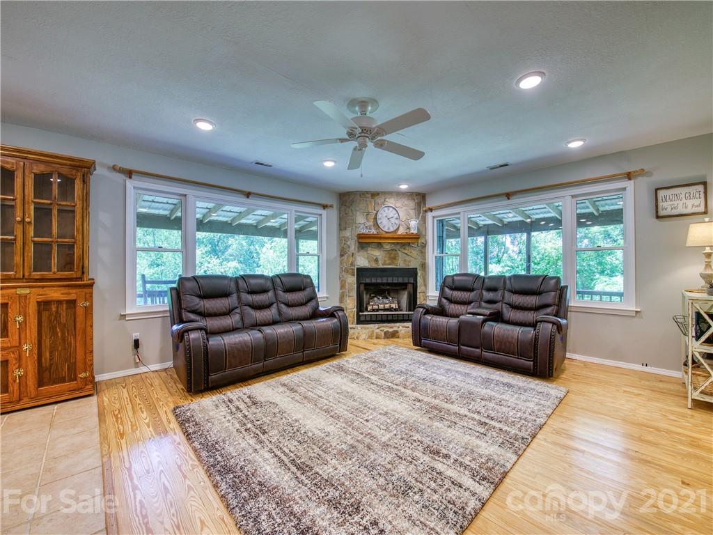 685 Osborne Road Clyde, NC 28721 - Photo 10 of 30 a living room with furniture a flat screen tv and a fireplace