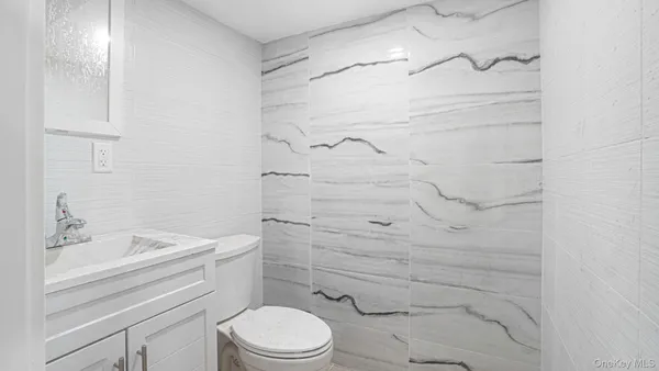 a bathroom with a shower a toilet and sink