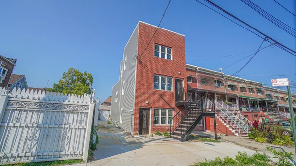 a front view of a house with iron fence